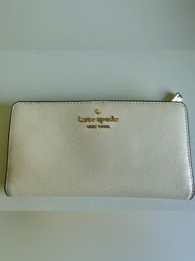 kate spade cream saffiano zip-around wallet with gold logo
